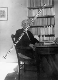 BLANCHOT : Photographie originale de Maurice Blanchot assis à sa table de travail devant la bibliothèque - Erste Ausgabe - Edition-Originale.com